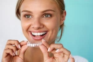 Young woman in West Vancouver holding Invisalign